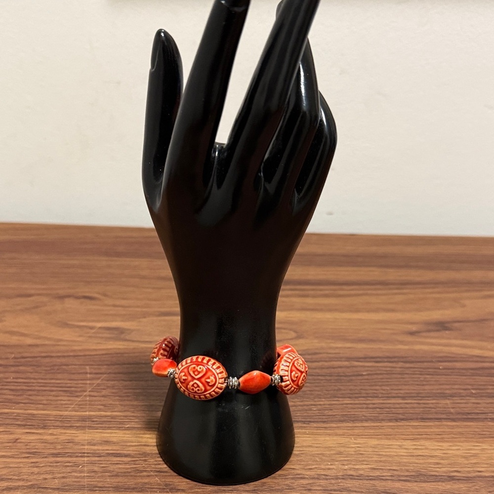 Carved Red Orange Beaded Vintage Bracelet with Silver Tone Decorative Spacers.